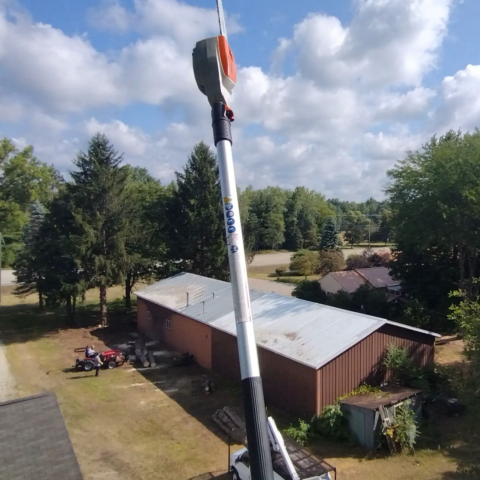 Bucket equipment working above a Mid Michigan home